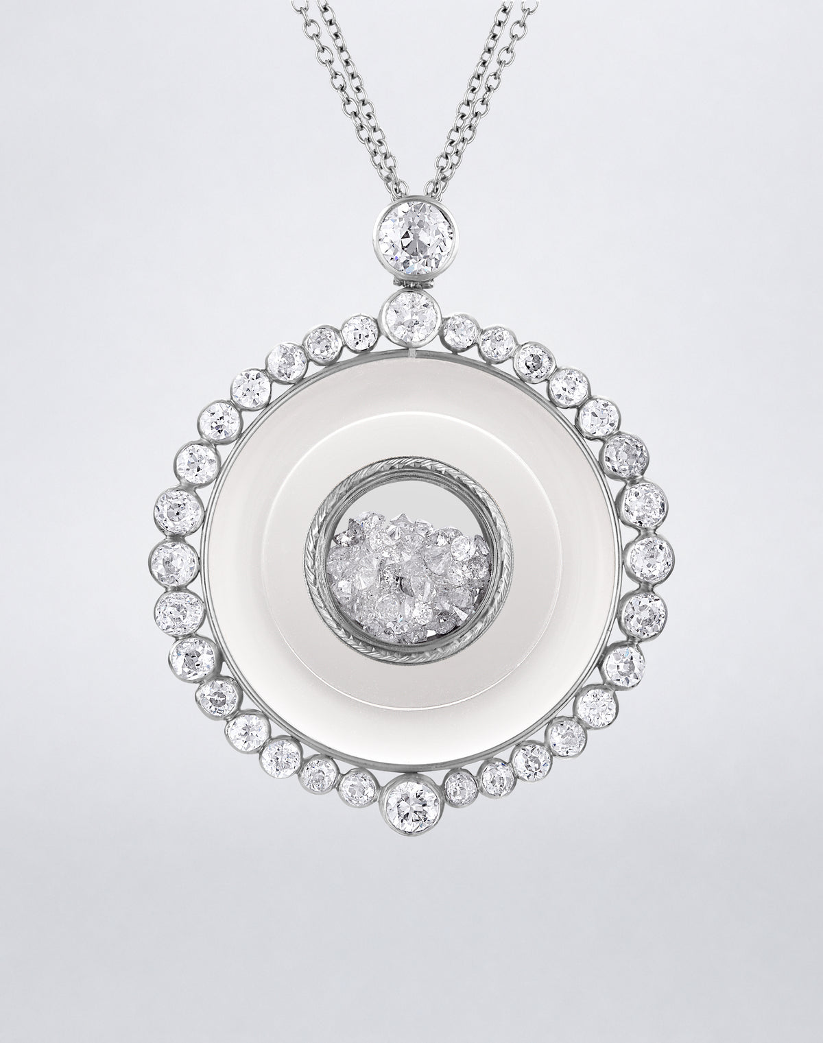 One-of-a-kind Diamond and Crystal Shaker Medallion Necklace featuring loose diamonds enclosed within a clear crystal center and framed by round diamonds.