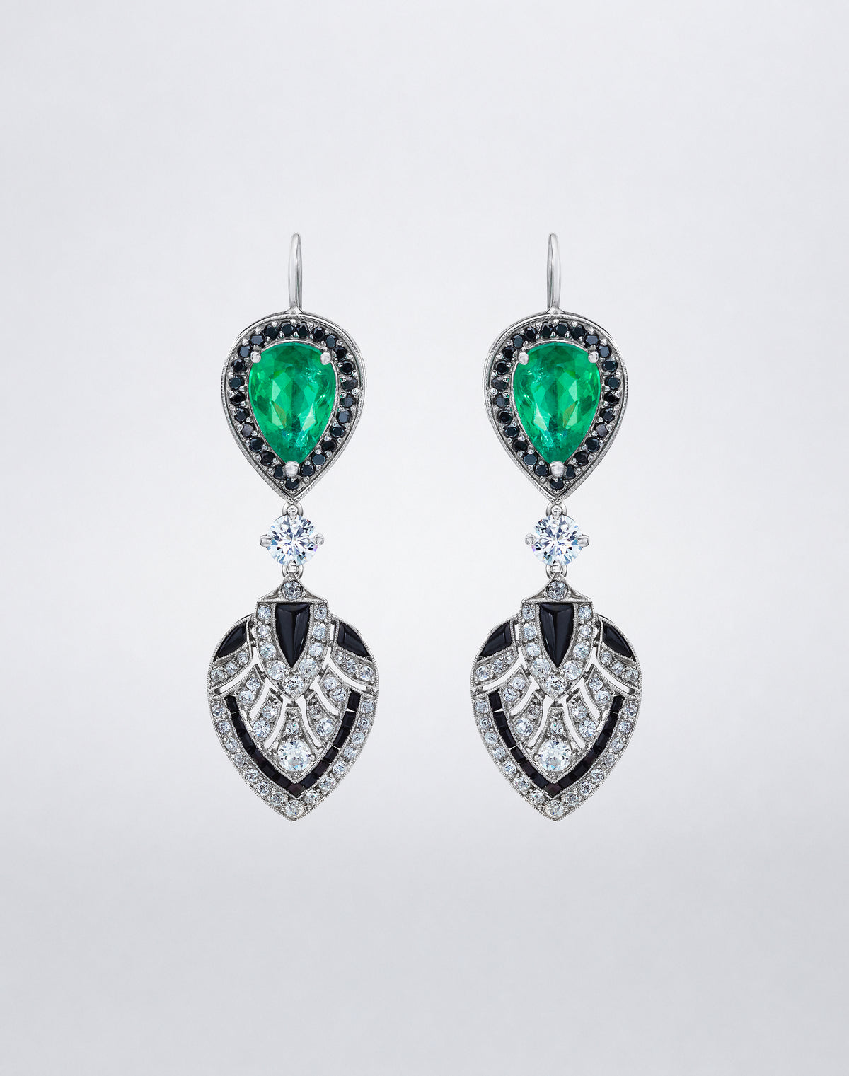 One-of-a-kind Emerald and Diamond Shield Earrings featuring pear-shaped emeralds framed by black diamonds, with geometric white diamond shield drops set in platinum.