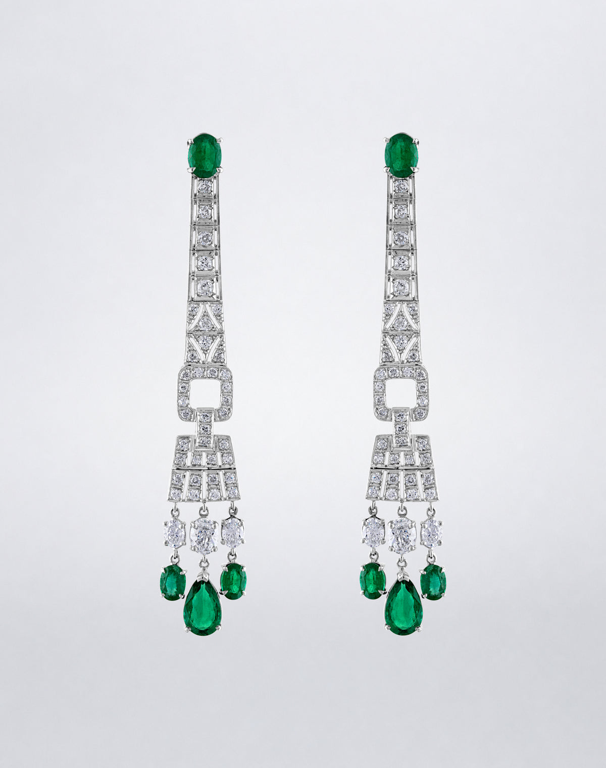 One-of-a-kind Emerald Shoulder Duster Earrings featuring oval and pear-shaped emeralds with diamonds in long articulated geometric drops.