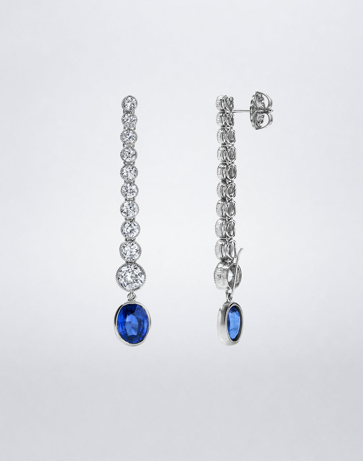 Side view of the one-of-a-kind Milgrain Diamond and Sapphire Line Earrings showing the articulated diamond settings and suspended blue sapphire drops.