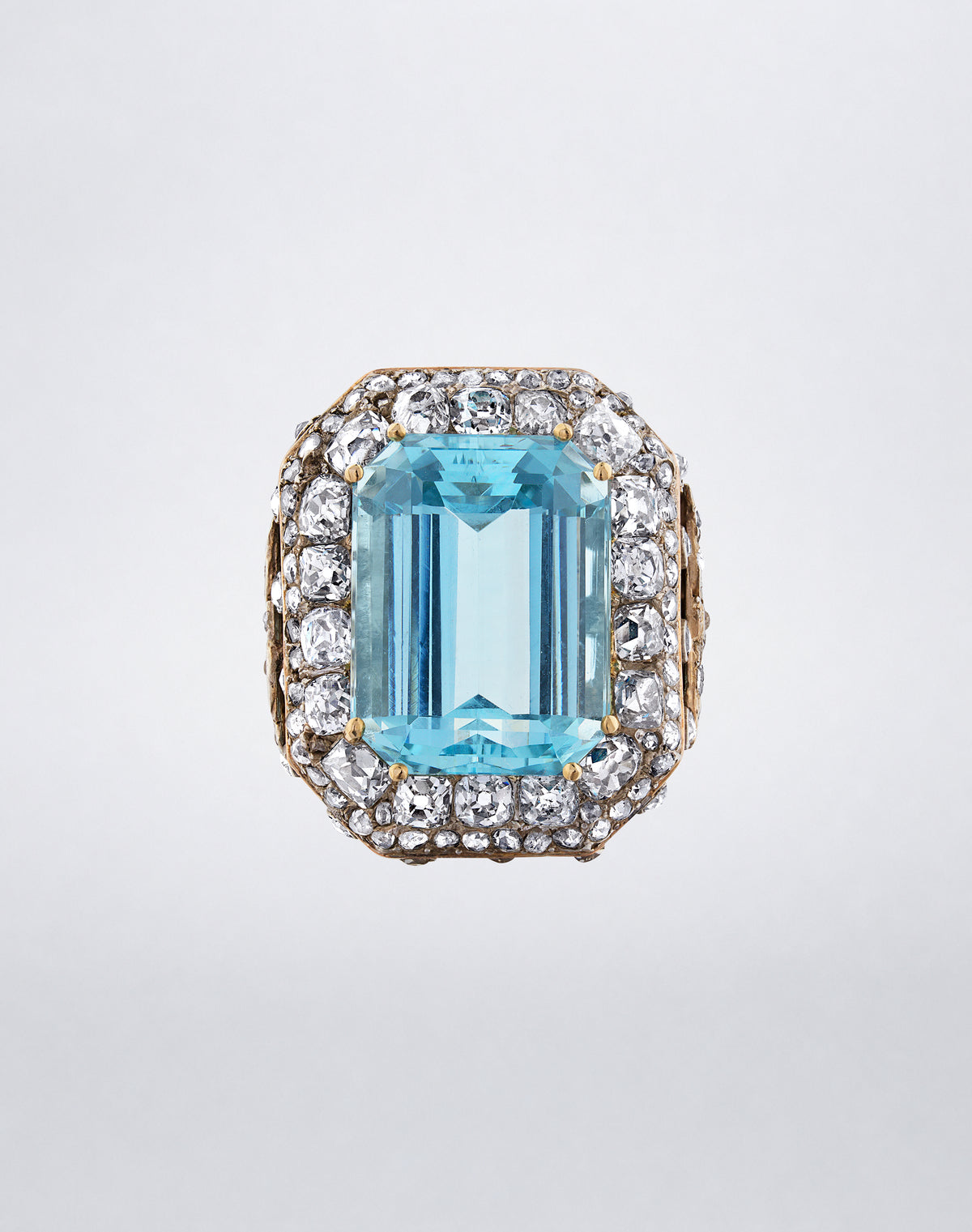 One-of-a-kind Octagonal Aquamarine Ring featuring a step-cut aquamarine framed by old mine, rose-cut, semi-faceted, single and round diamonds in a silver-topped 14K yellow gold Victorian mount.