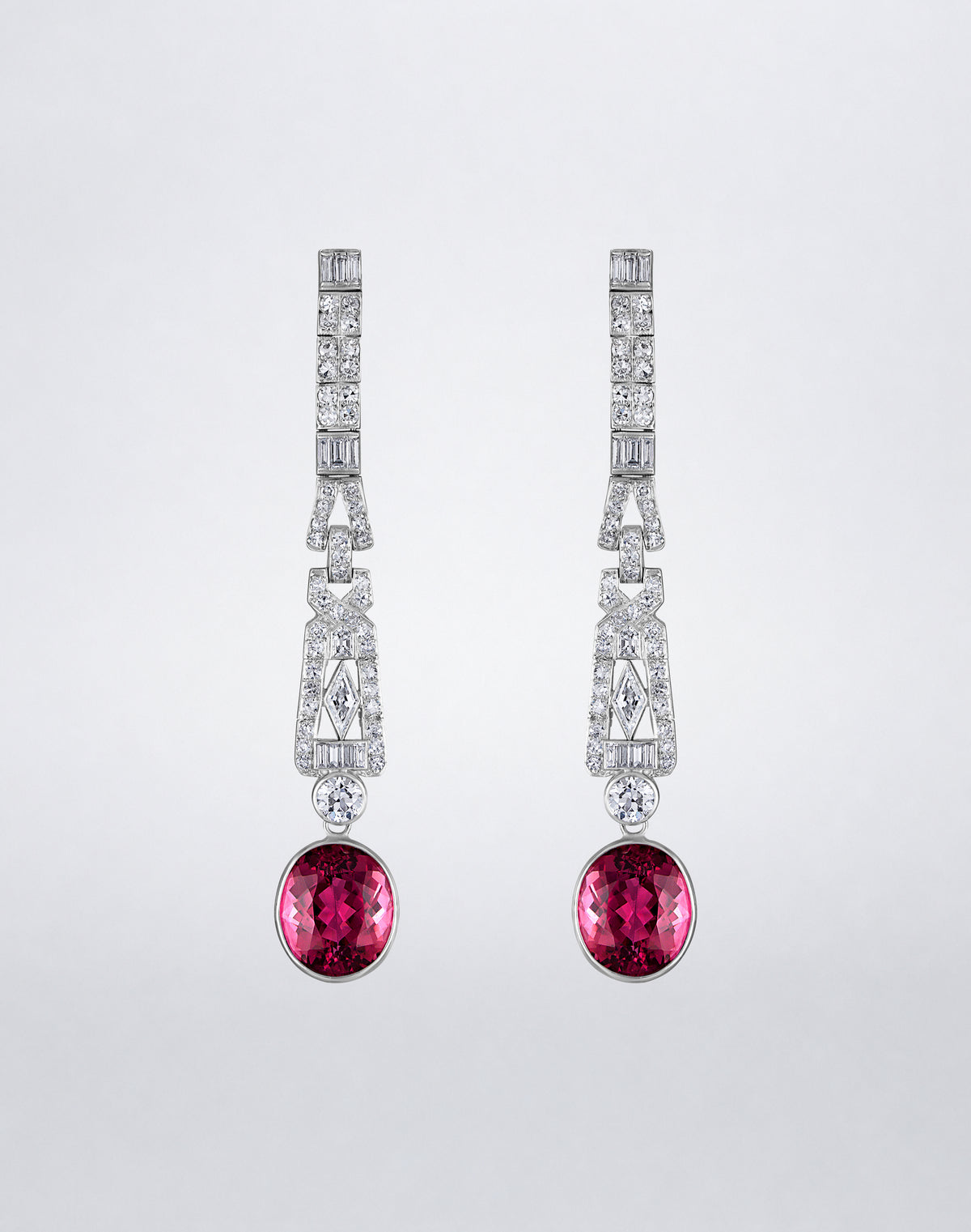 One-of-a-kind Pink Tourmaline and Deco Diamond Earrings featuring oval pink tourmaline drops suspended from geometric mixed-cut diamond settings.