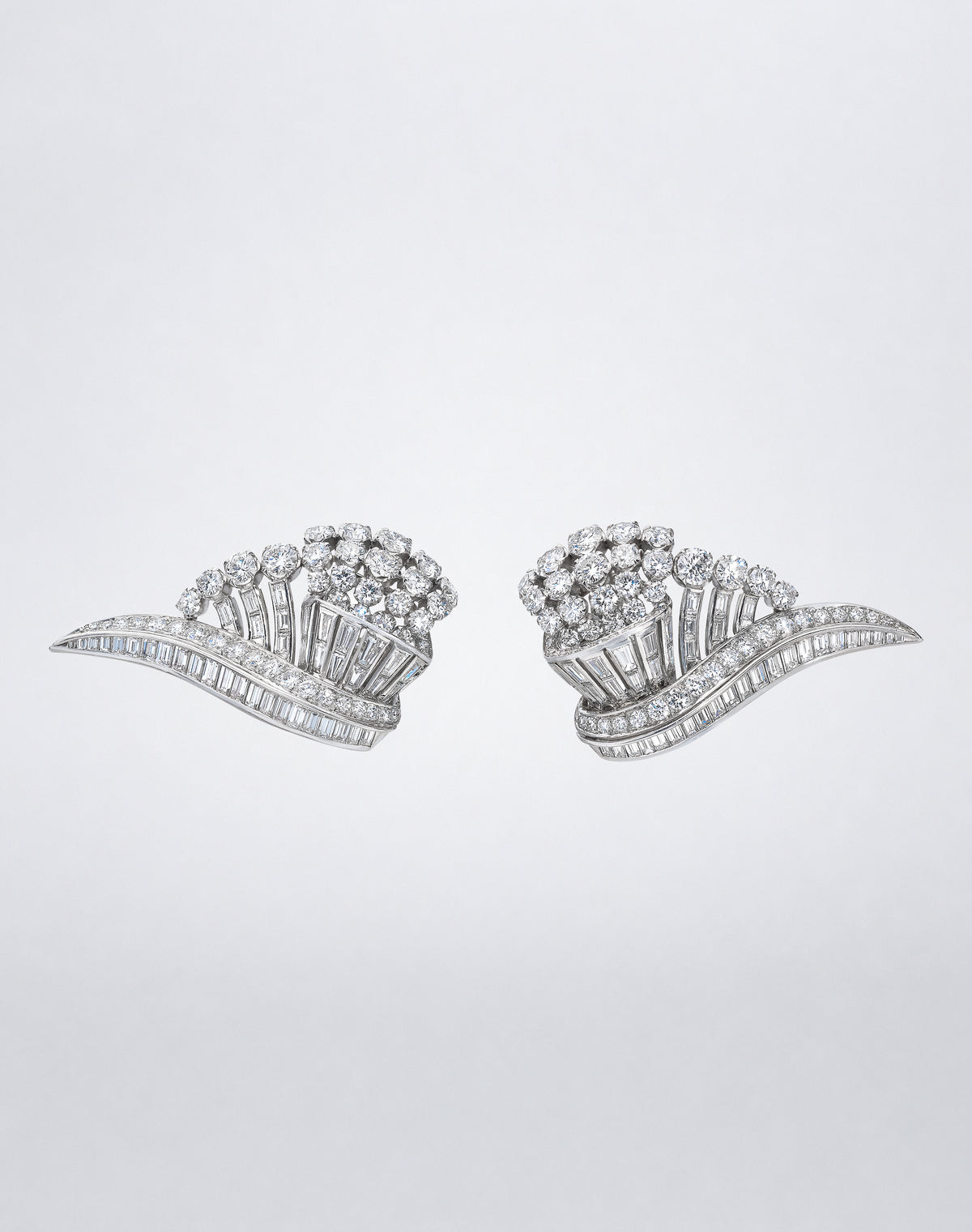 One-of-a-kind Platinum Diamond Wing Earclips featuring sculptural wing-shaped designs set with round and baguette diamonds in platinum.