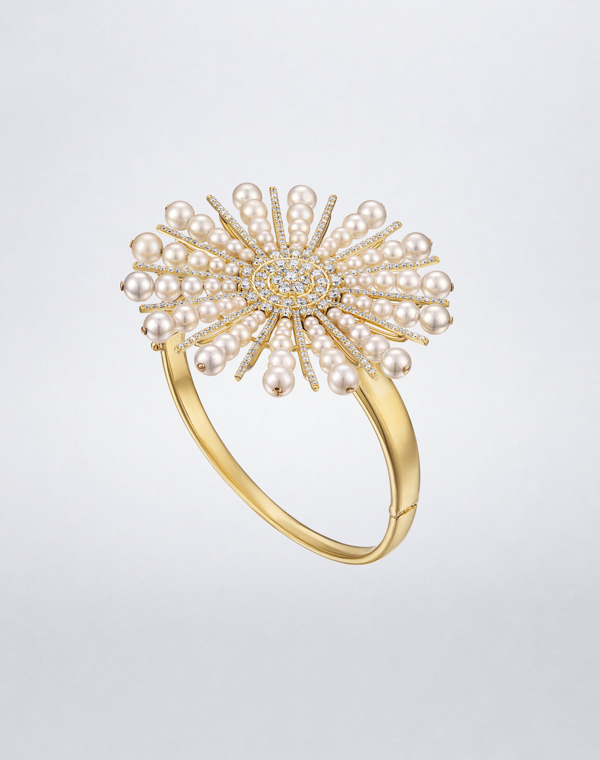 Mindi Mond New York SPOKE pearl and diamond bracelet in 18K yellow gold, angled view showing the wide hinged cuff and raised starburst
